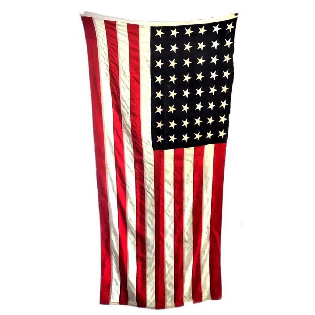 48 star Wool American Flag Navy Ensign: An ensign is the national flag flown on a vessel to indicate nationality. The ensign is the largest flag, generally flown at the stern (rear) of the ship. This United States Navy Ensign is marked: U.S