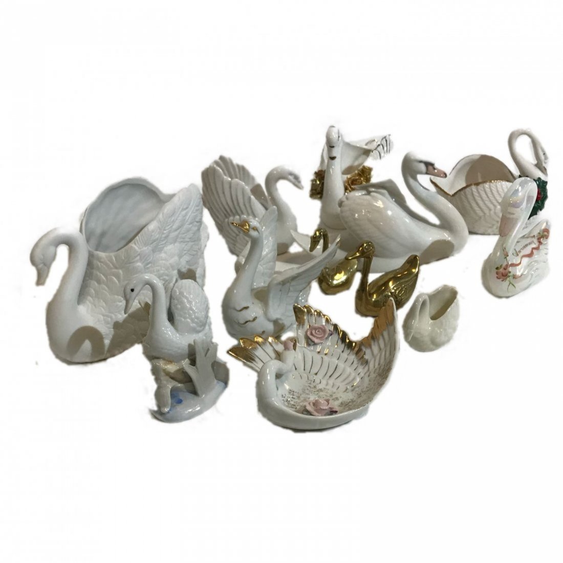 Lot of 12 Porcelain Swans: This is a mixed lot of collectible swan figuriens. The lot includes, A 1989 Fenton Swan - 40 th Anniversary, vintage Royal Cophenhagen swan-Denmark, number 755 and Victoria Czech, number 2093, and a