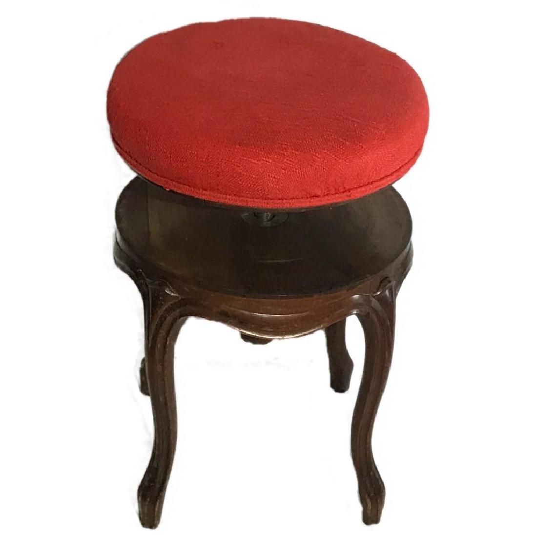 Vintage Adjustable Piano Stool: Here is a nice wooden piano stool. It has a Red upholstered cushion. This stool measures approx. 15" diameter x 18" tall.