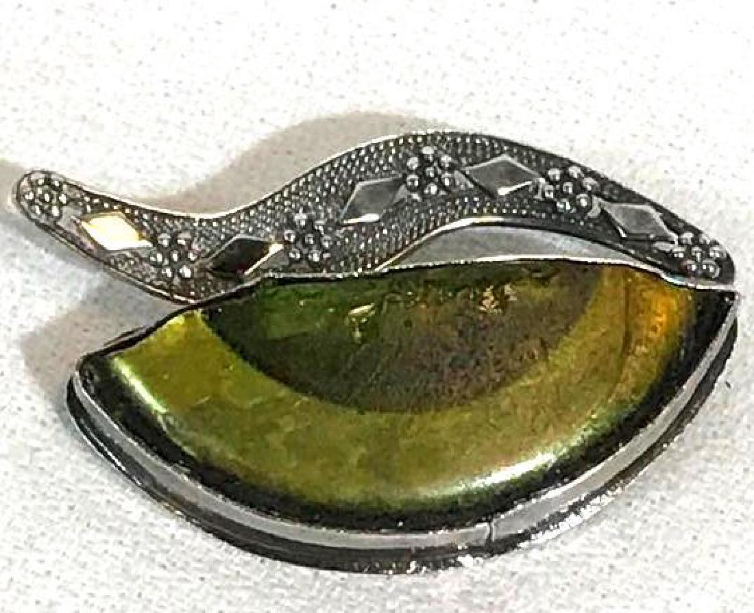 Art Deco silver and Glass Brooche: This antique silver and green glass pin has a very cool Art Deco look to it. The green glass looks as if it may have been an old bottle. It is signed but I was not familiar with the signature. It 