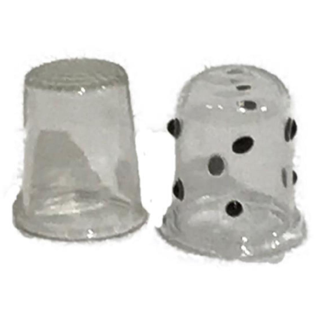 2 Antique glass Thimbles: Two antique glass thimbles. One is done in a traditional thimble top with clear glass surround, the other is clear glass with black raised black polka dots. They are approximately 1" tall by .75" 