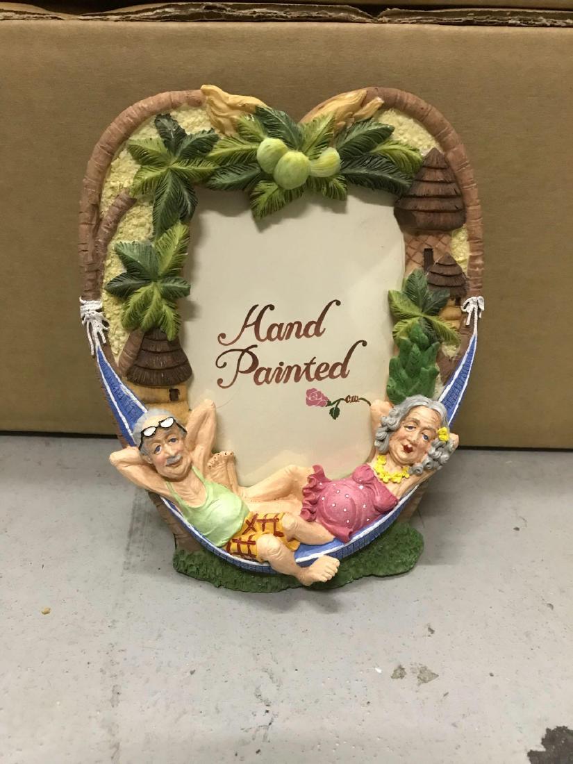 22 Beach Old Man Woman Picture Frames: 22 resin picture frames. They feature an elderly couple sharing a hammock on the beach. They measure approximately 6.5â€ wide by 5â€ tall.