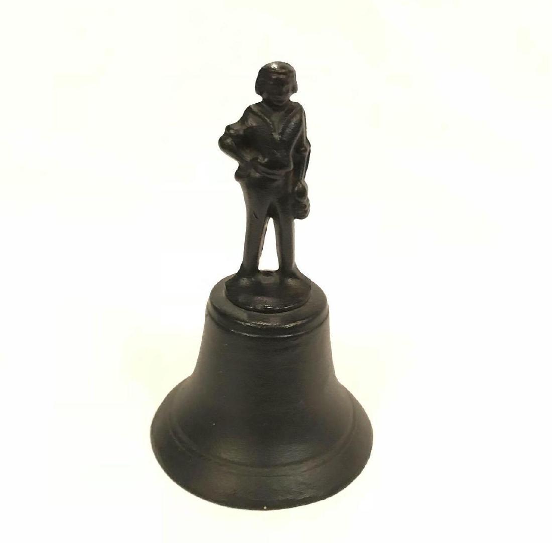 Vintage Cast Iron Bell: One heavy vintage cast iron bell.Â It appearsÂ to have a Dutch Boy standing on top. Measures approximately 7" x 4 ".