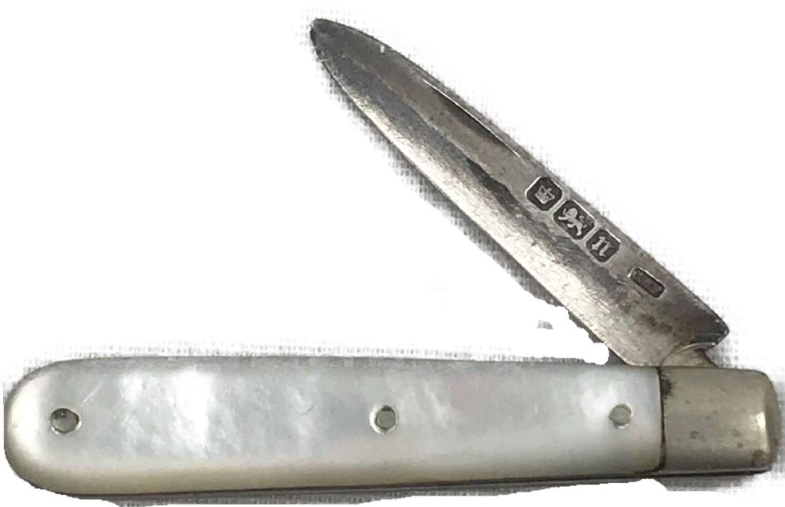 Small Pearl Handle Pen Knife Sterling Silver Blade: This is a vintage pocket knife. The handle had a shimmery pearl handle. The blade is stamped with The British Lion Passant, the Sheffield town stamp, the N date code and C.W.F for Charles William Flet