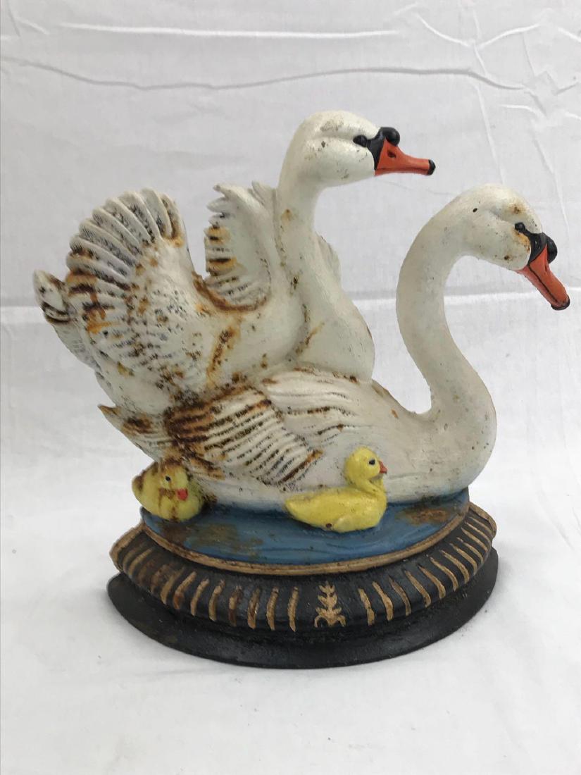 Swans Cast Iron Doorstop: One heavy cast iron doorstop featuring two swans. It has some rust and patina on it to give it that vintage look. This piece measures approximately 9.5ï¾” across and 11ï¾” tall. -JPT