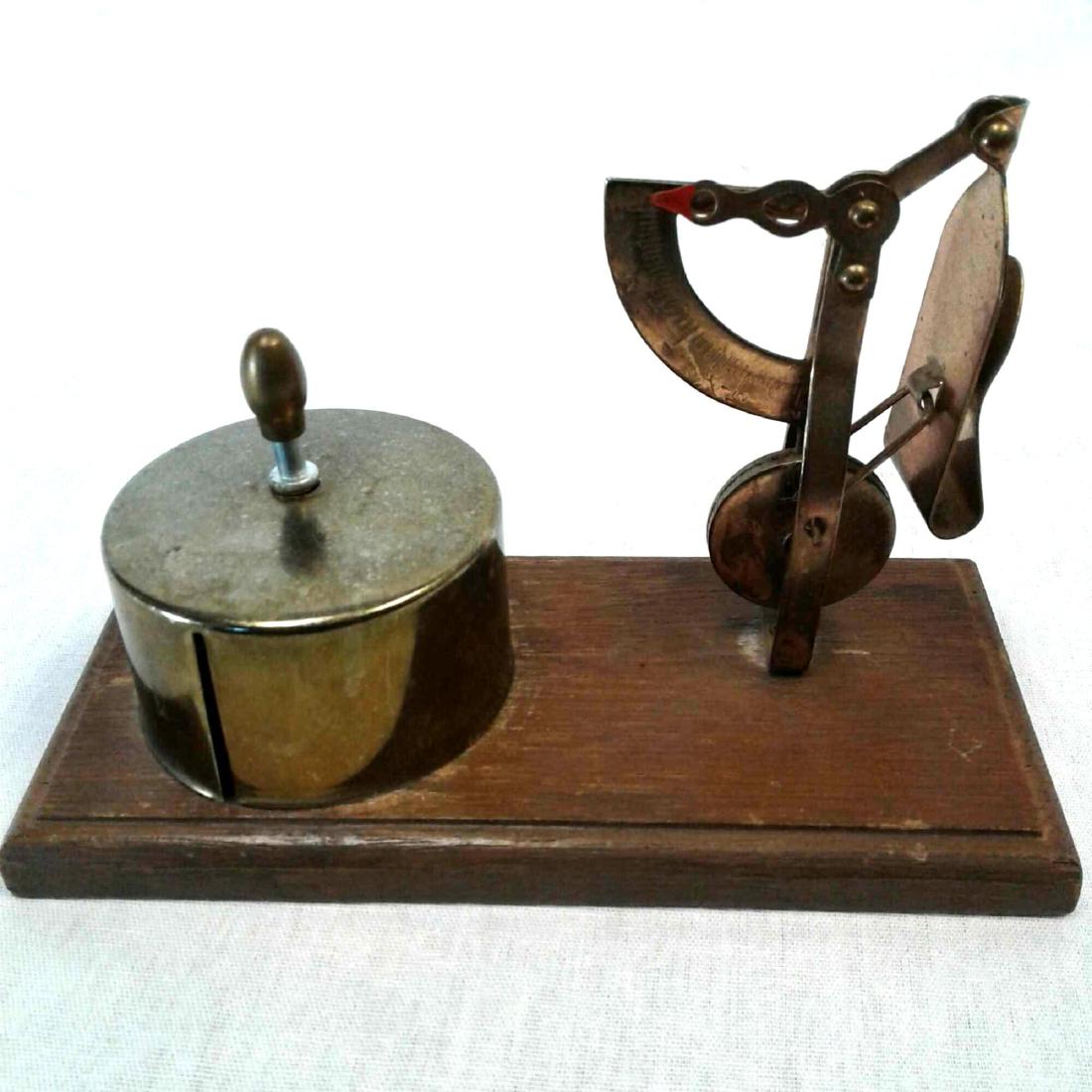 Postal Scale and Stamp Dispenser: Postal Scale and Stamp Dispenser, mounted on walnut base, vintage balance type postal scale and stamp dispenser all in brass, measures 5 1/4" L x 2 1/2" W x 3 1/2" H.