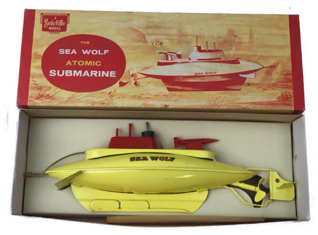"Sea Wolf" Clockwork Tin Diving Submarine Toy Boat: "Sea Wolf" Clockwork Tin Diving Submarine Toy Boat; a toy submarine from the world famous Sutcliffe Pressings LTD of Horsforth near Leeds, England. This tinplate toy is a great example of British craf
