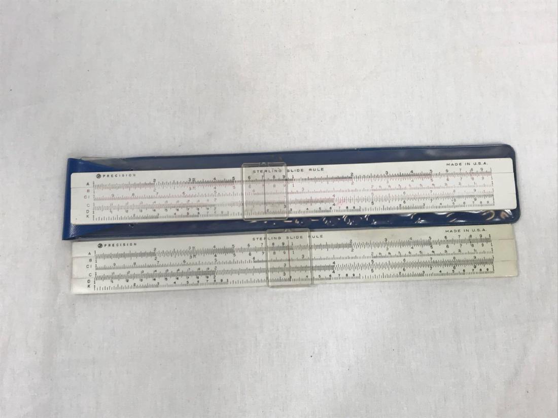 2 Vintage Sterling Precision Simplex Slide Rules: Two Sterling Precision Simplex slide rules by Sterling Plastics of Mountainside, New Jersey. One rule has the B and C scales in red and is stored in original plastic pouch. Sterling manufactured slide