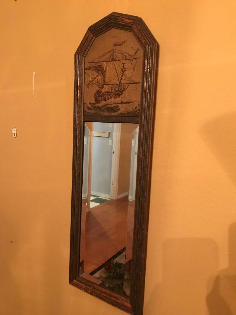 Antique Beveled Mirror with Needlepoint Ship: Antique Beveled Mirror with Needlepoint Ship; this is a beveled mirror and jacquard tapestry produced by the La France Art Company in the early 20th century. The work is in fair condition with the nee