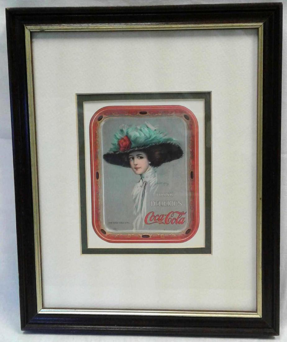 Framed and Matted Coke Girl: Framed and Matted Coke Girl; a tasteful mounting of a vintage style Coca Cola advertisement showing a Gibson like Girl, "The Coca-Cola Girl," in a stylish hat .. This piece is glazed and double matte
