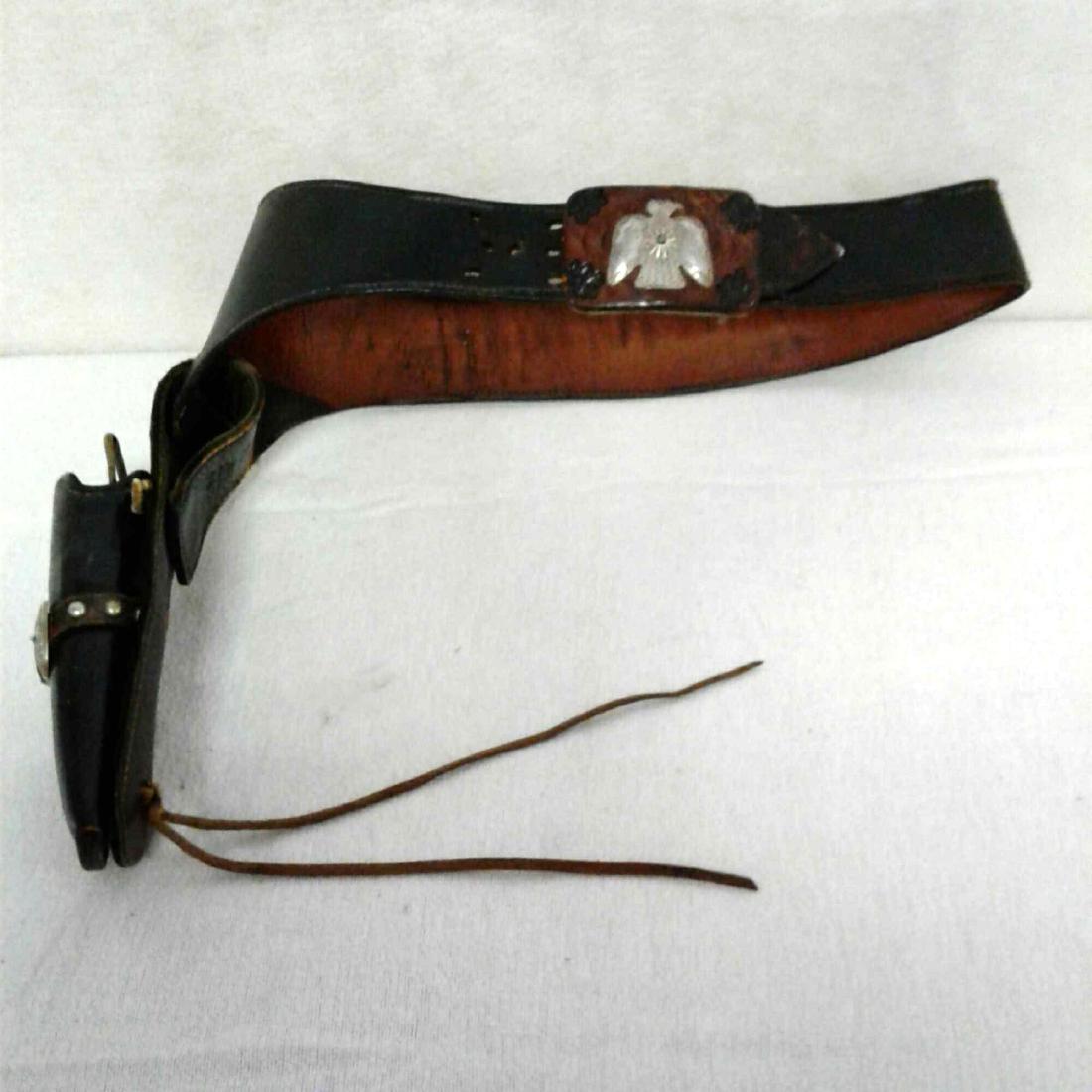 Leather Western Belt and Gun Holster: Black and Brown Leather Gun Belt and Holster from old western times. Appears to be handcrafted with a nickle silver and with thick genuineÂ leather. In the bullet holders are 5 bullet shells. There 