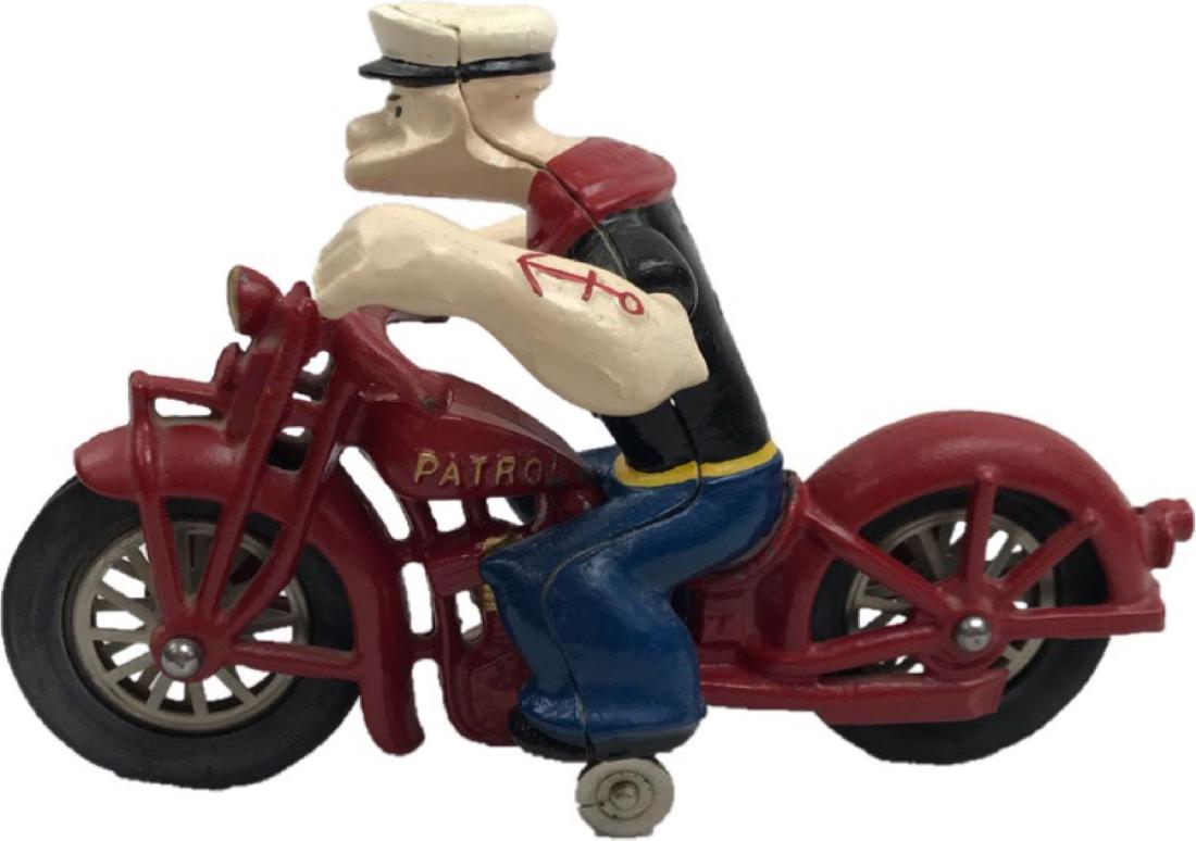 Vintage Cast Iron Hubley Popeye on Motorcycle Toy: Vintage Cast Iron Hubley Popeye on Motorcycle Toy; a cast iron motorcycle with tough guy, hero, sailor Popeye speeding to save Olive Oyl (from that dastardly Bluto no doubt). The motorcycle is mar