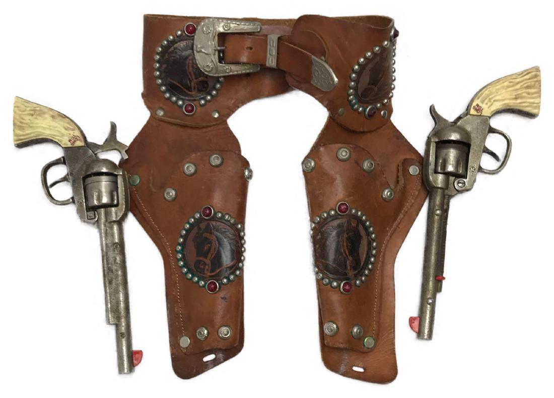 Kilgore Long Tom Cap Pistol Pair with Gun Belt: This item is a rare vintage pair of Kilgore €œLong Tom € Six Shooter Toy Cap Gun with a vintage gun belt. These cast iron cap guns appear to be all original. They are completely automati