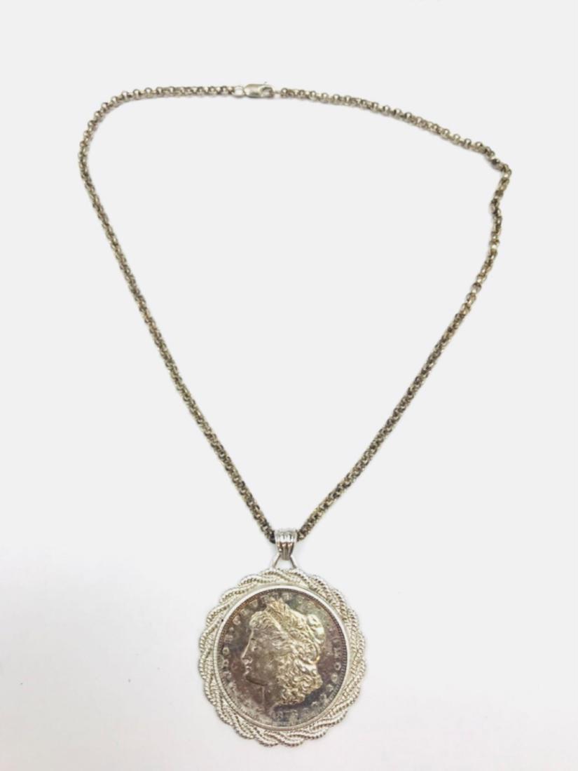1878-S Morgan Silver Dollar Necklace: One Morgan Silver Dollar minted in San Francisco in 1878. It is housed in a sterling silver coin holder pendant and sterling silver chain. Produced for more than 40 years, the Morgan Silver Dollar was