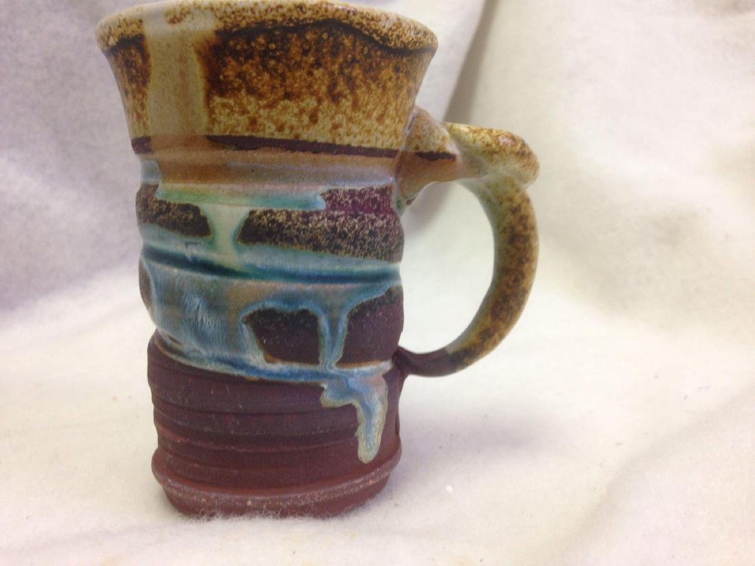 fun Clay Salt Glazed Pottery Cup: Here is a nice hand-made cup made from Terra Cotta Clay by a potter. I wonder if his name was Harry? If not whomever the Artisanis who crafted this fine cup did an amazing job. Size: 5" high, Material