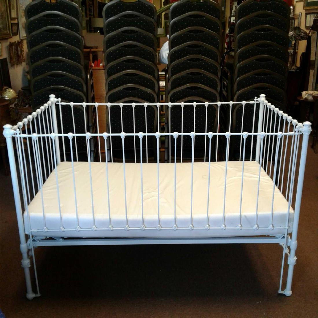 Vintage White Iron Baby Crib: Vintage White Iron Baby Crib, very nice ornamentation, measures approximately 40" H x 60" W x 37" D.
