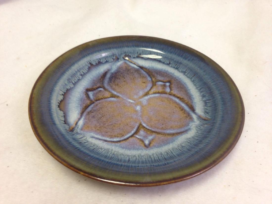 handmade Stoneware plate with 3 leaves in blue: Here is a fine ceramic stoneware cheese plate with a "three leaf" design. The blue and purple colors are amazing, vibrant, yet cool. Sign by the artist: Illegible. Size: 8.5" diameter. Conditi