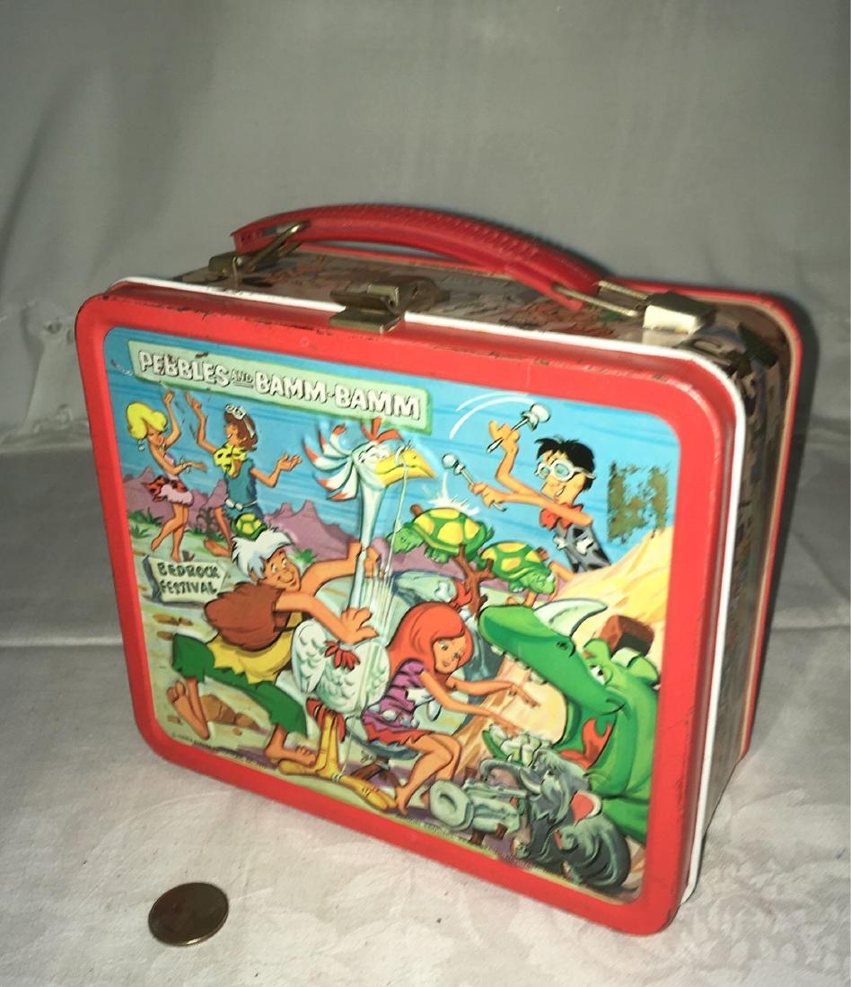 Vintage Flintstones Lunchbox Circa 1970's: Vintage Flintstones Lunchbox Circa 1970's; Featuring Pebble and Bam Bam at the Bedrock festival on the outside and includes the thermos. It measures at approximately 3 1/2" L x 7 1/2"W x 7" H.