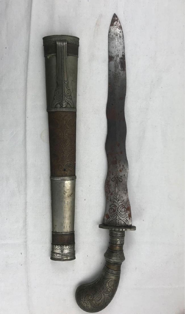 Antique Filipino Moro Kris Sword: Antique Filipino Moro Kris Sword; this is a very fine example of a Moro Kris sword. The hilt, guard and scabbard are all metal. The handle is finely engraved, the blade is engraved and the scabba