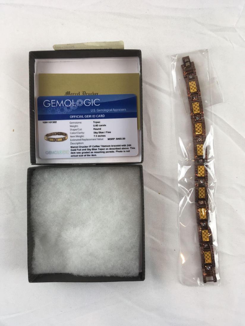 Vintage Marcel Drucker Blue Topaz Bracelet, New in the: Vintage Marcel Drucker Blue Topaz Bracelet, New in the Box another beautiful piece. A titanium bracelet showing blue topaz stones and 24 K gold foil. It is in new condition and measures 7 1/2" L.