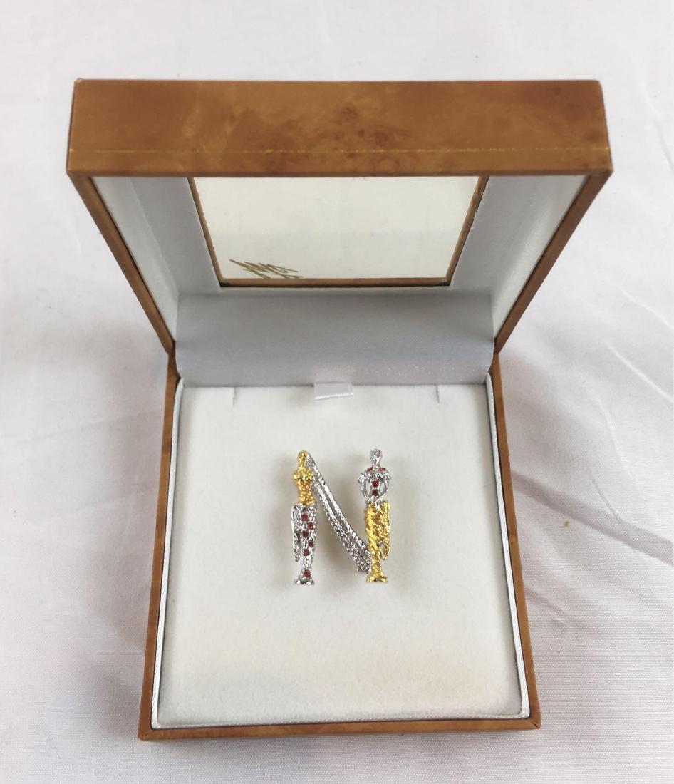 Erte Alphabet Brooch "N", New in the Box: Erte Alphabet Brooch "N", New in the Box a gold plated sterling brooch with Swarovski red crystals in Art Deco style. New condition.