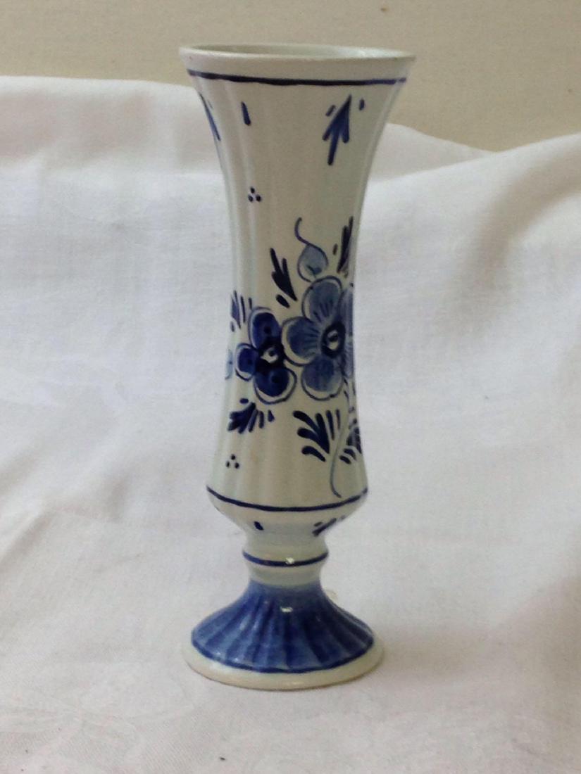 Vintage Floral Delft Blue Vase Made in Holland: Here is a vintage floral Dutch Delft Blue vase stamped with the date on 1980. This earthenware is in good condition measuring 6 high. There are 2 hairline cracks at the lip of the vase.