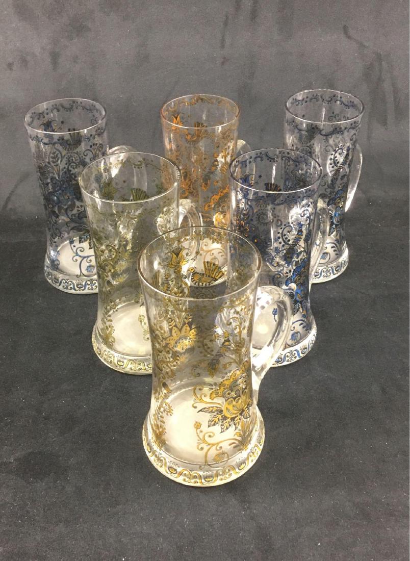 6 Vintage West German Glass Beer Mugs: 6 Vintage West German Glass Beer Mugs; three of these show an ornate appled design in blue, three show the design in gold. Two of the mugs show a label "Made in Western Germany". Five of the mugs are