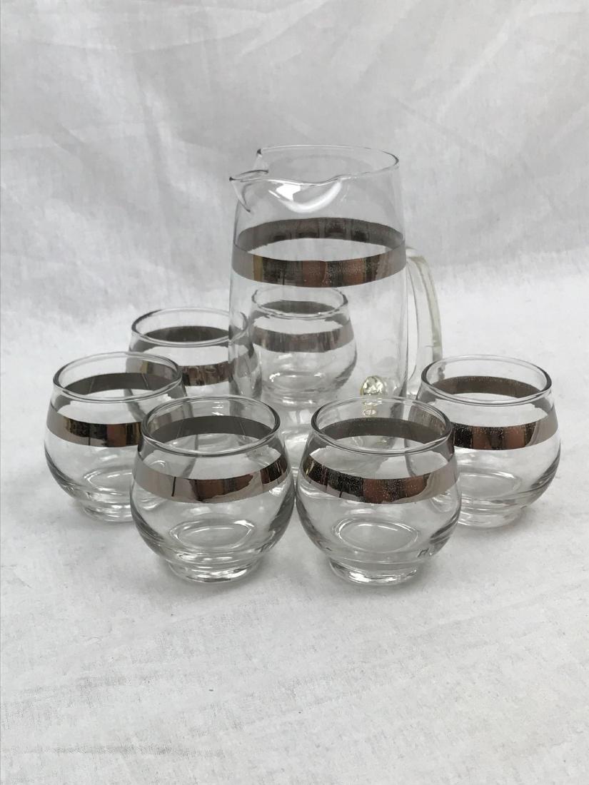 Vintage Libbey Glass Silver Platinum Rim Cocktail Set: Here is a set of 6 vintage roly poly glasses which have a silver trim on them, and it comes with a martini pitcher.Â These are made by libbey and can be seen in many Mad Men Episodes.Â These are