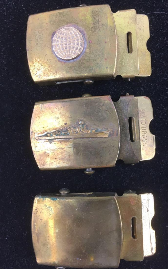 Vintage Military Web Brass Belt Buckle Lot: Lot of 3 vintage brass belt buckles in the military or Boy Scout style. One is made by RAU and features a long and lat line globe. The second is an RAU and is blank. The third has no make and features