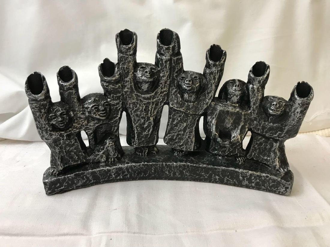 Pewter Artistan Menorah: Pewter Artisan Menorah; Comes complete with 9 candle stick holders. It measures at approximately 7" H x 11" W.