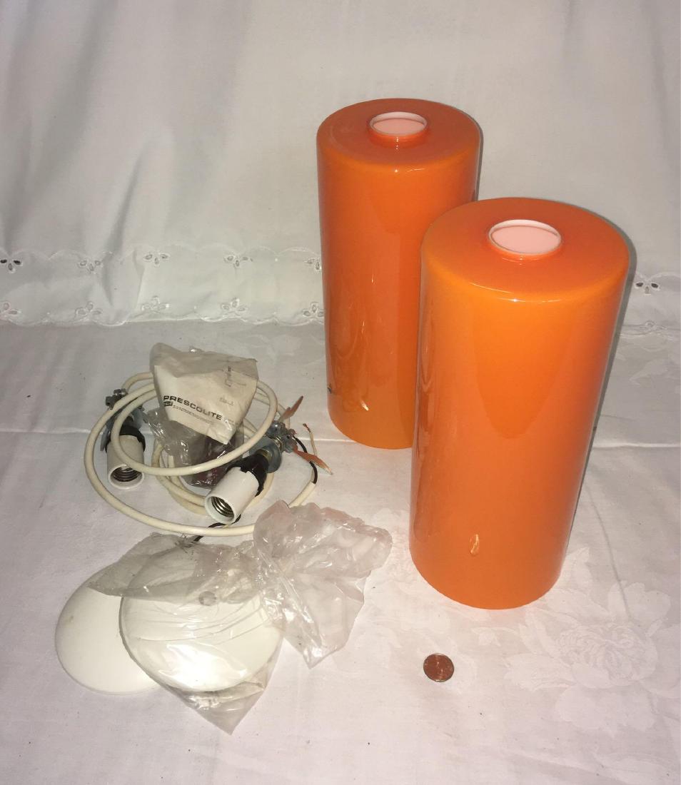 Vintage Pair Of Orange Pendant Lamps By Prescolite: Vintage Pair Of Orange Pendant Lamps By Prescolite; Circa 1960's and each measure at approximately 12" H x 5" D. Cord and hardware included. Mid Century Modern, creamsicleÂ orange and white.Â