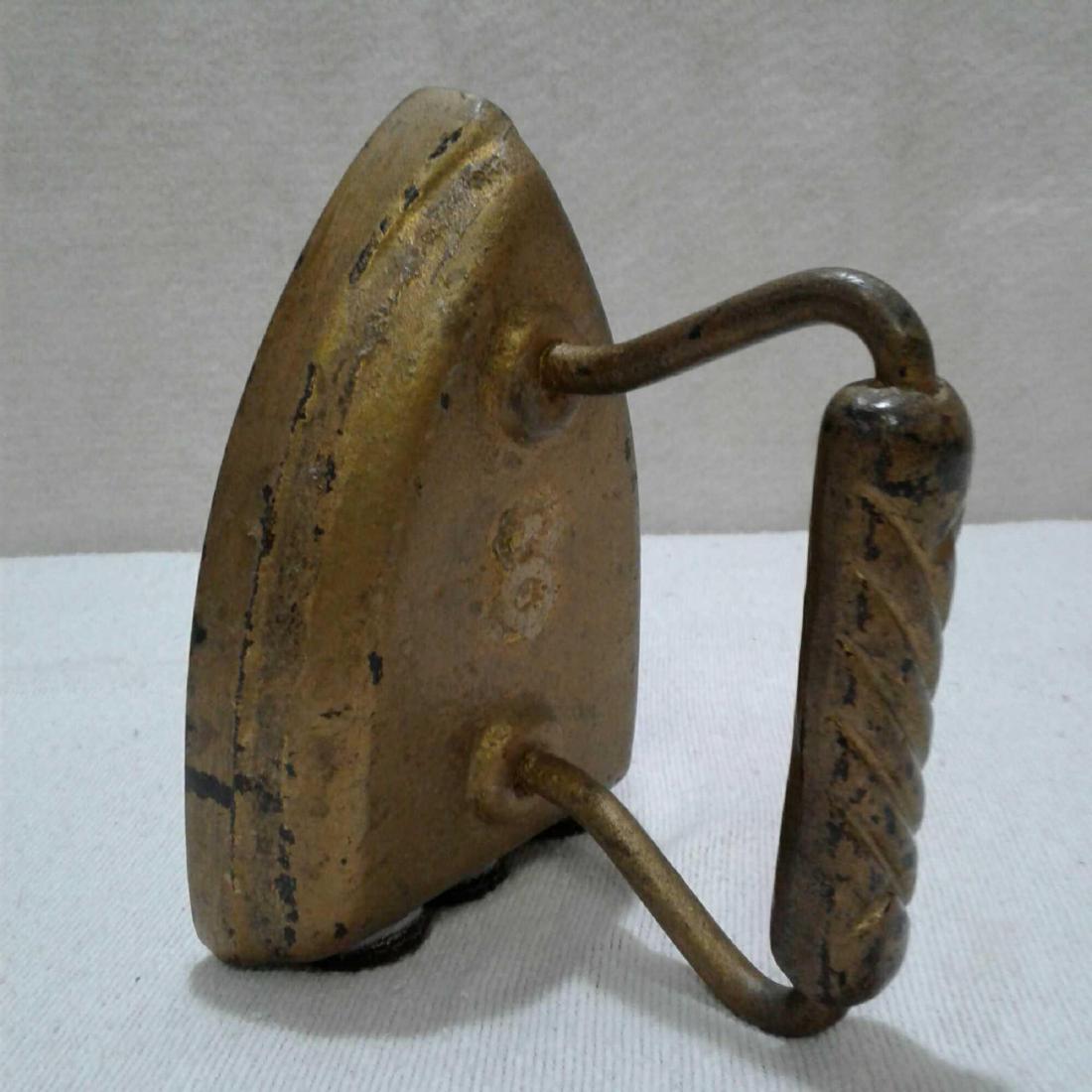 Antique Cast Iron, Iron Painted Gold: Vintage Cast Iron, Iron. This iron has been painted gold and was used as a doorstop. It measures approximately 6.5" x 4" and is in good used condition. There are paint chips and fades, and may need ne