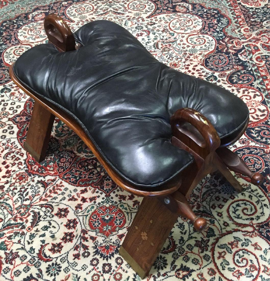 Vintage Camel Saddle Stool: Vintage Camel Saddle Stool; a very fine example of an Egyptian style camel saddle. This piece shows high quality workmanship and materials. The frame is nicely finished hardwood. There are brass tips 
