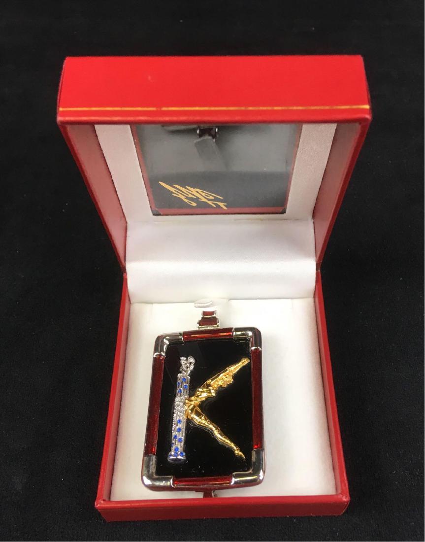 Erte Alphabet Letter K Pendant: ErteÂ Alphabet Letter K Pendant; New in box, Art Deco Style with gold toned and sterling silver with blue sapphires. It measures at approximately 2 1/2 L x 1 1/2" W