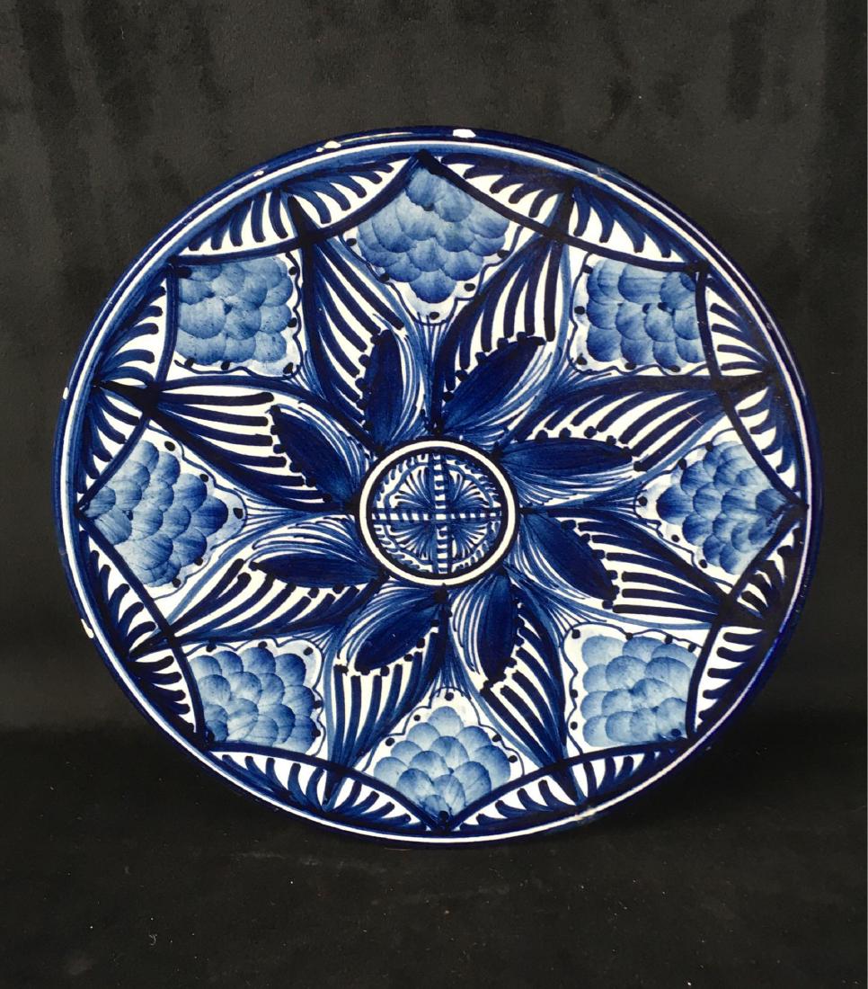 Vintage Hand Painted Decorative Plate Blue on White: Vintage Hand Painted Decorative Plate; the origins are unknown, possibly Spain or Portugal. It is signed by the maker. This plate is in good condition, it does show some minor chipping on the outside 
