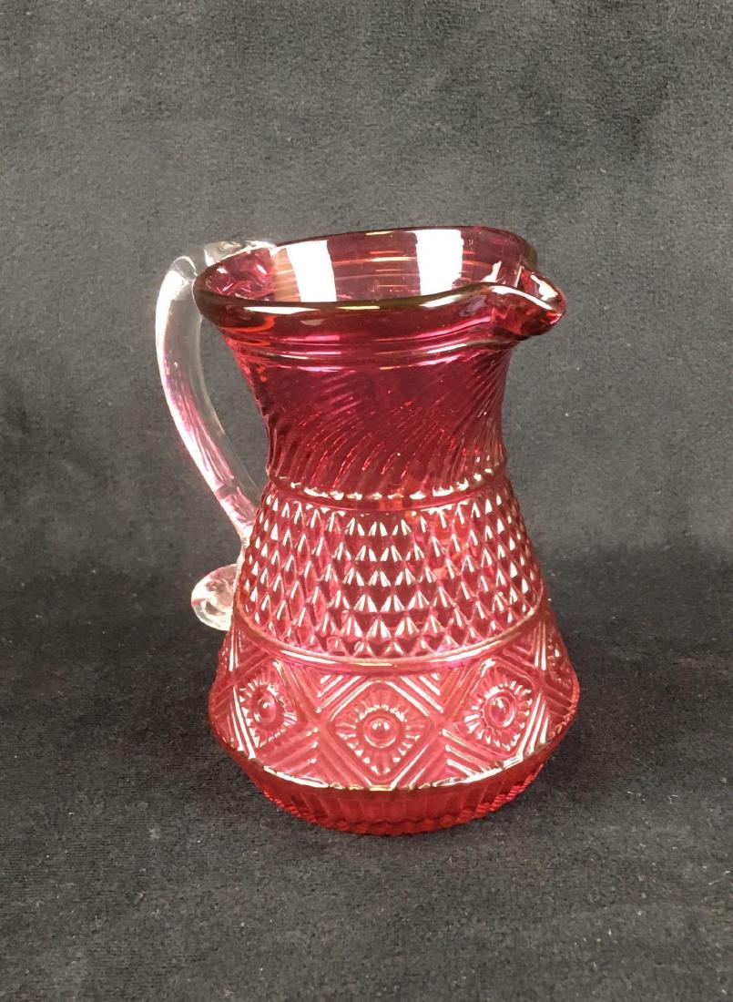 Vintage Pilgrim Cranberry Glass Creamer Pitcher: Vintage Pilgrim Cranberry Glass Creamer, Pitcher; this pretty little pitcher is in excellent condition. There are no chips or cracks noted. It measures 3 1/2" W x 4 1/4" D (w/ handle) x 4 1/2" H.