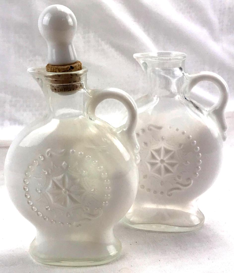 2 Jim Beam Milk Glass Liqour Decanter: 2 Vintage Opalescent Milk Glass Decanter Pitcher White with blue hues Jim Beam Liquor decanter.Â One is missing its stopper.Â the bottles measure approximately 9" tall by 5" across.Â Â