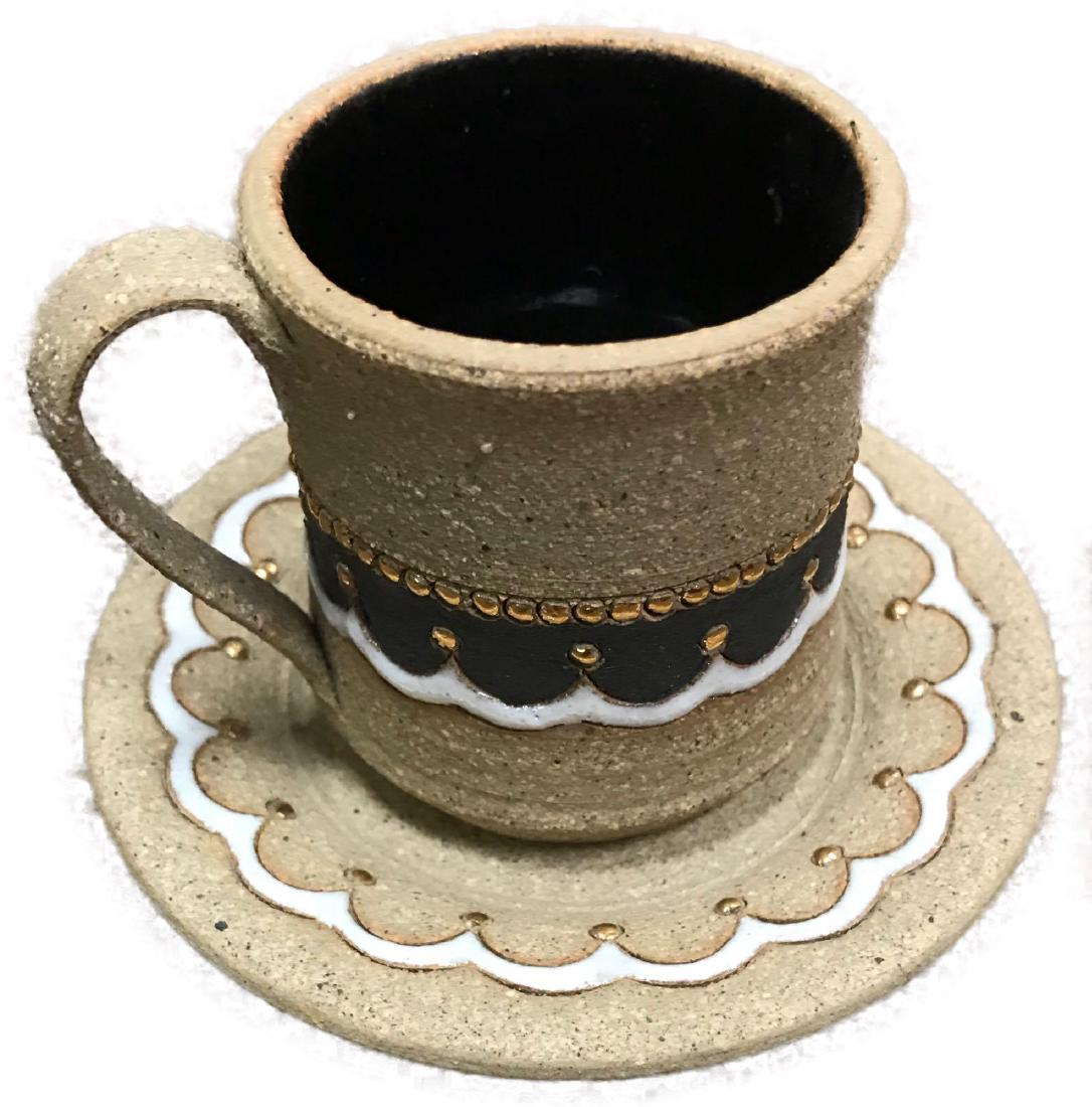 Landing Pots Mug and Saucer Pottery: Landing Pots Mug and Saucer Pottery; a very nice earthenware set of tea cup and saucer. They are each marked "Landing Pots". The set has a nice earth toneÂ with accents in white and gold. Condition 