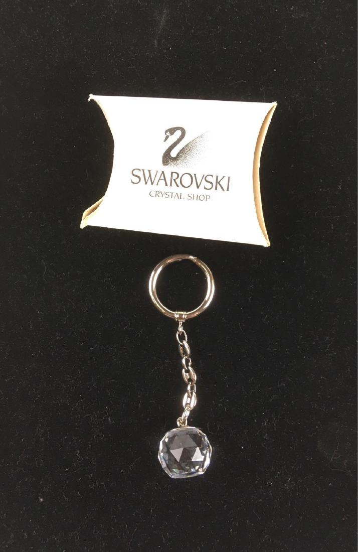 Swarovski Crystal Key-chain with the Black Eagle of: Swarovski Crystal Key-chain with the Black Eagle of Austria; a fine crystal globe on a silver colored chain. When viewed from from the flat face, the coat of arms of Austria shows in very fine detail.