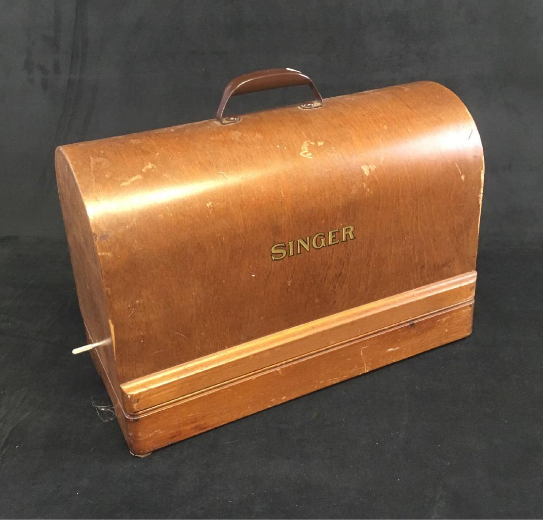 Vintage Portable Singer Sewing Machine Circa 1940's: Vintage Portable Singer Sewing Machine, Circa 1940's; mounted in the original bentwood case. It shows the serial # AJ262954. This machine has the foot operated control, is tested and works with a very