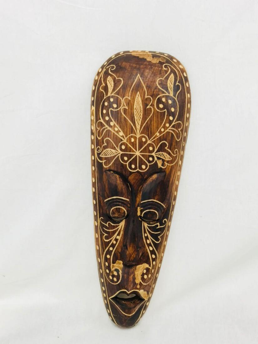 Hand Carved Tiki God Polynesian Art: This hand-carved tiki mask resembles popular Totem and Tiki culture that is mainly associated with ancient Polynesian craftsmanship and symbolism. It's approximate measurements are 19.5" tall by 6.25"