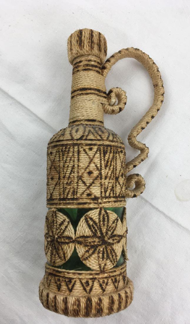 Jute Wrapped Bottle in Mediterranean Style, Signed: Jute Wrapped Bottle in Mediterranean Style, Signed; this piece is well executed, it is signed by the artist on the bottom. The quality of work and the accent added by the use ofÂ hot irons leads us 
