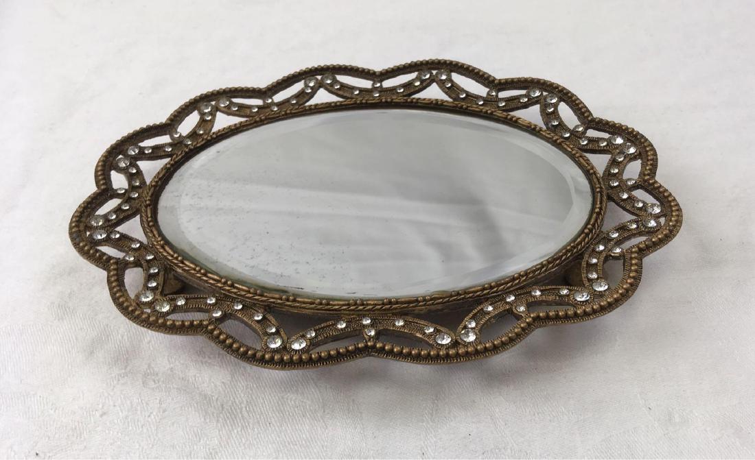 Mirrored Beveled Trinket Tray: A small, bejeweled trinket tray with mirror. Perfect for your chest or nightstand. Measures Approx. 7.1/2" L, 5.1/2" W, sits 3/4" in the air.