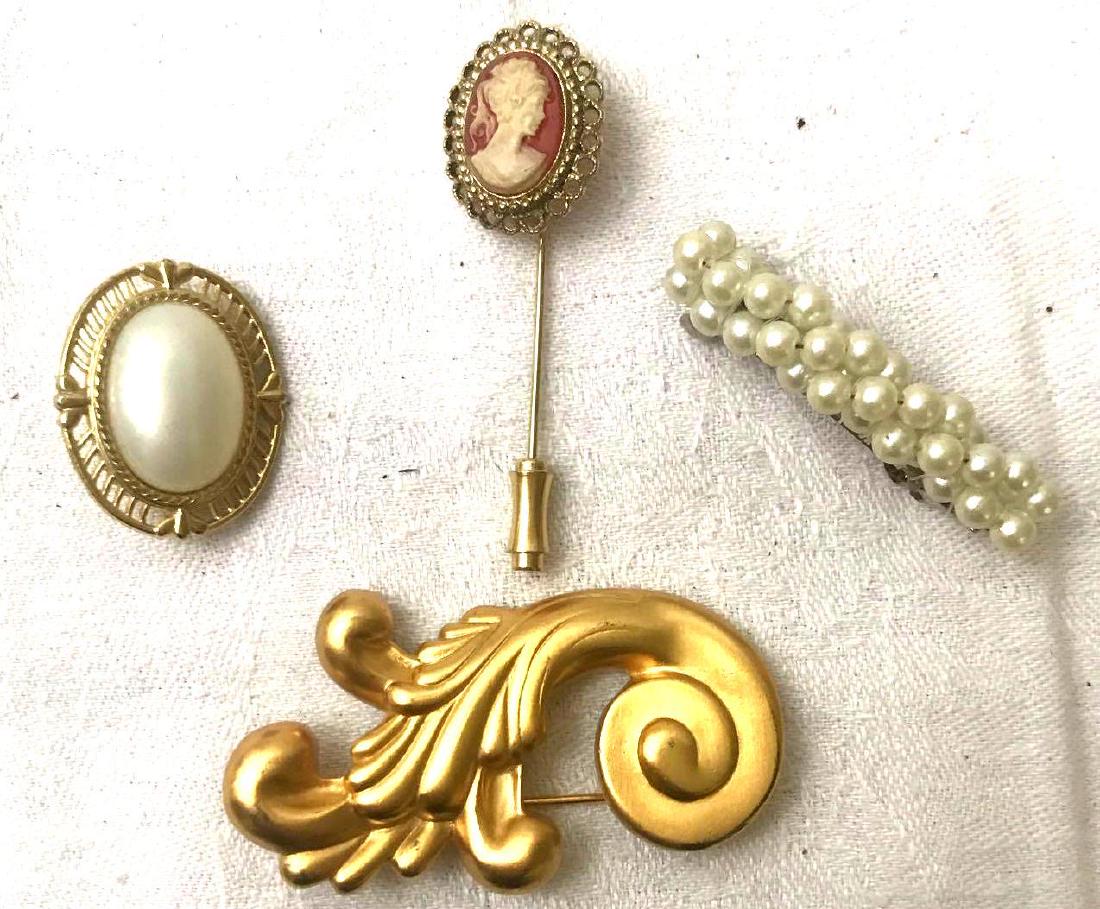 Vintage Assortment Of Brooches: Vintage assortment of brooches;Â Faux pearl, shell Cameo, gold bouquet and faux pearl and gold tone button.Â Each vary in style and size.Â