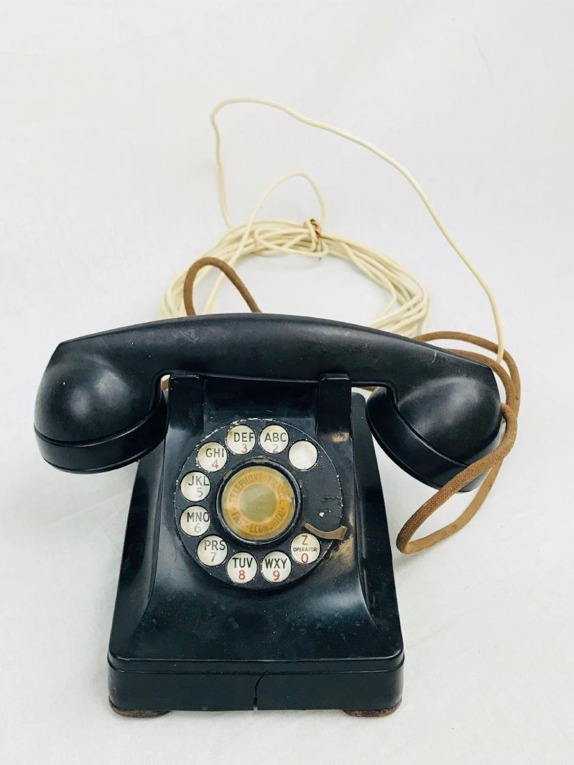 Vintage Bakelite 302 Rotary Dial Telephone by Western: Vintage Bakelite 302 Rotary Dial Telephone by Western Electric, Circa 1940's; this is a WW II era Bakelite telephone. It appears complete with transmitter and receiverÂ mounted in the handset, we ha