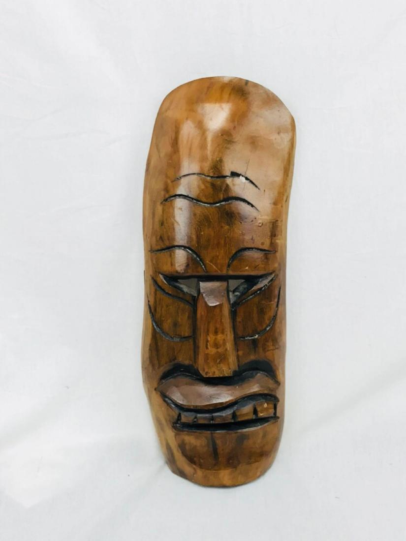 Hand Carved Tiki God Polynesian Art: This hand-carved tiki mask resembles popular Totem and Tiki culture that is mainly associated with ancient Polynesian craftsmanship and symbolism. It's approximate measurements are 17.75" tall by 7" a