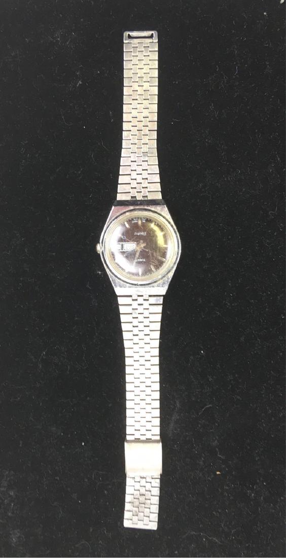 Vintage Electric Timex Mens Watch: Vintage Rare Electric Timex Mens Watch; Believed to be circa 1970's, when Hong Kong was an English colony. It has a black face that includes the day of the week and month. The watch face has some sign