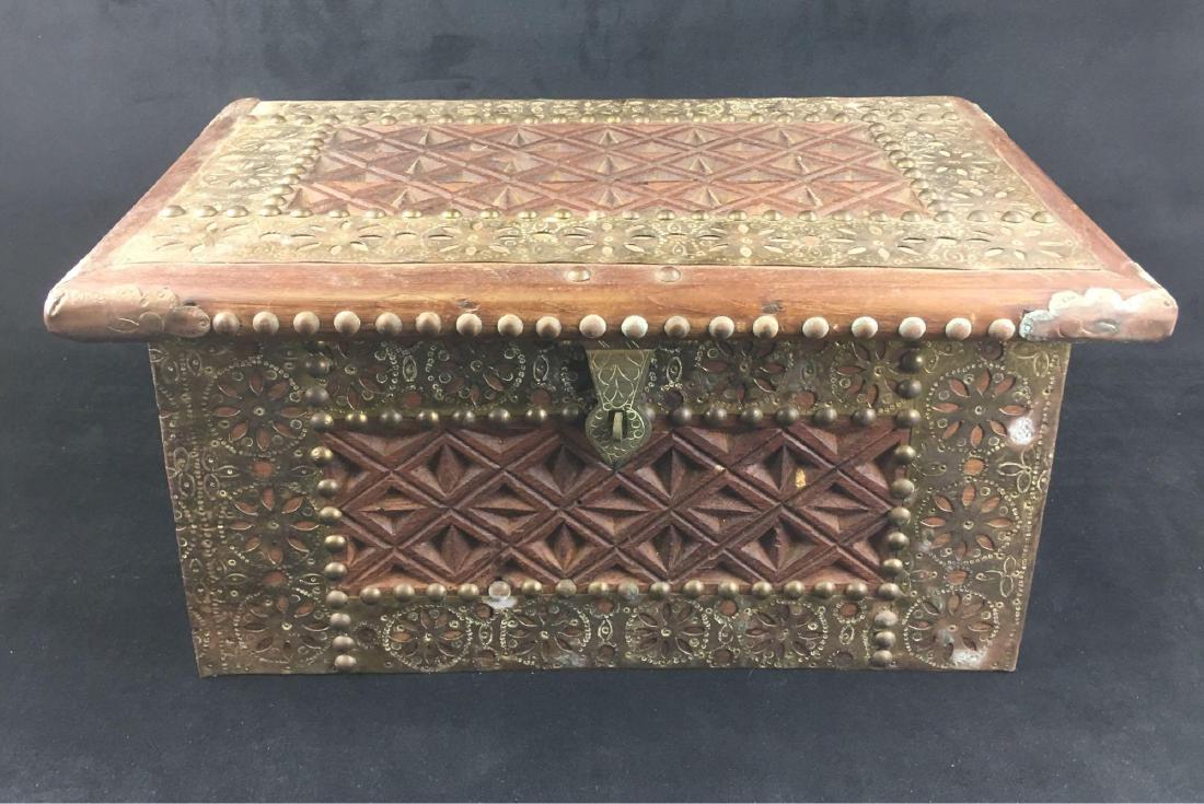 Vintage Rosewood and Brass Zanzibar Chest: Vintage Rosewood and Brass Zanzibar Chest; a beautiful and exotic piece. This small rosewood chest shows much carving in a Moorish geometric pattern. There is tooled brass sheet applied, brass corner 