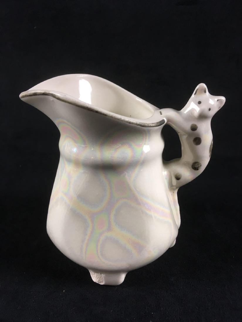 Vintage Lusterware Cat Handle Creamer Pitcher Marked: Vintage Lusterware Cat Handle Creamer Pitcher Marked Czecho-Slovakia; this is a very intriguing piece showing a subtle iridescentÂ lusterware pattern. The handle shows a little cat. The pitcherÂ i
