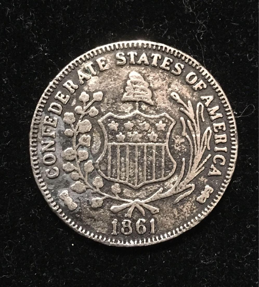1861 CSA Confederate Half Dollar Coin: Confederate States half dollar coin. This is possibly a commemorative restrike, but has no identifying marks to indicate that, either way. Coin has wear, but is in VG condition.Â Â